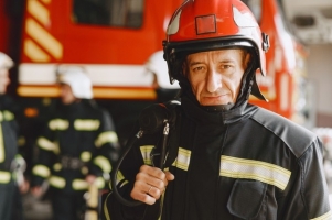 hombre-uniforme-fuego-bombero-cerca-coche-hombre-garaje_1157-46940